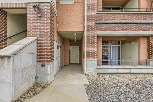 entrance to property featuring brick siding