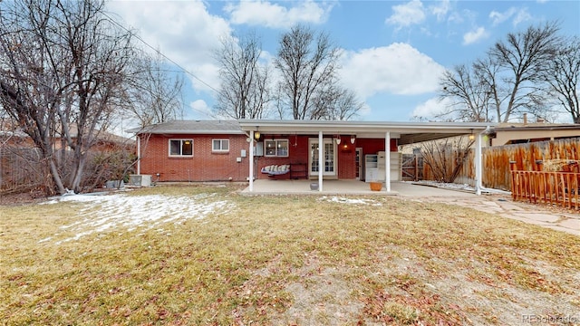 view of front of house with central AC and a front yard