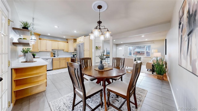 tiled dining room featuring sink