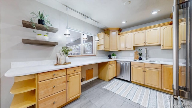 kitchen featuring light brown cabinetry, sink, hanging light fixtures, stainless steel dishwasher, and light tile patterned floors