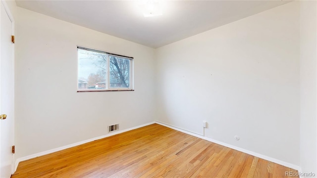 empty room with hardwood / wood-style floors