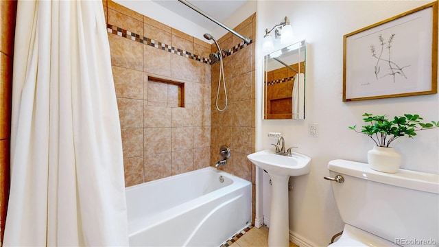 full bathroom with shower / tub combo with curtain, sink, and toilet