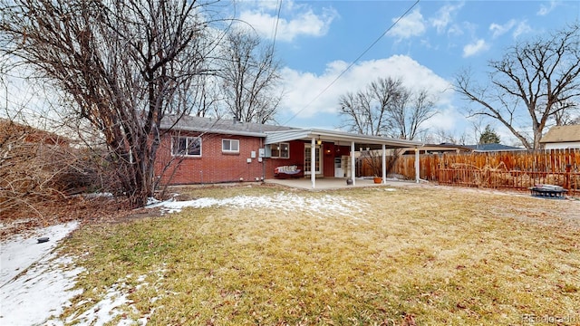 rear view of property featuring a patio area and a lawn