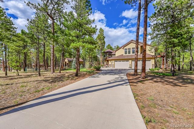 15947 Huckleberry Hts, Colorado Springs, CO 80908 - view of front of house featuring an attached garage and driveway