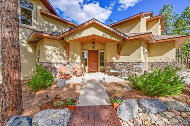 15947 Huckleberry Hts, Colorado Springs, CO 80908 - doorway to property with stone siding and stucco siding