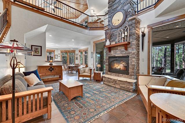 15947 Huckleberry Hts, Colorado Springs, CO 80908 - living area with a fireplace, recessed lighting, and a towering ceiling