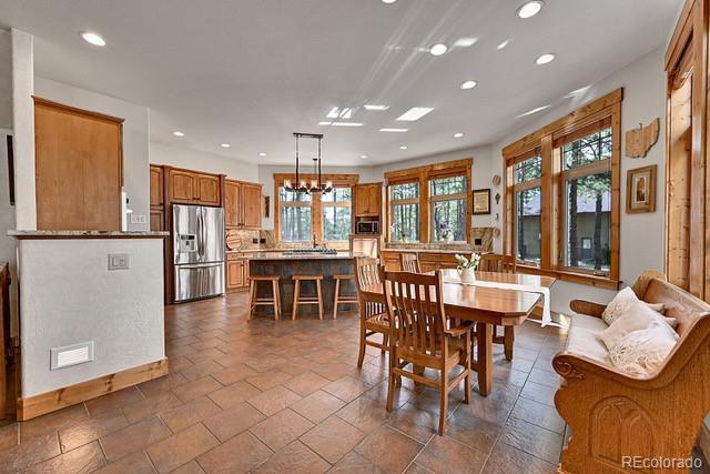 15947 Huckleberry Hts, Colorado Springs, CO 80908 - dining space with recessed lighting, a healthy amount of sunlight, and stone tile flooring
