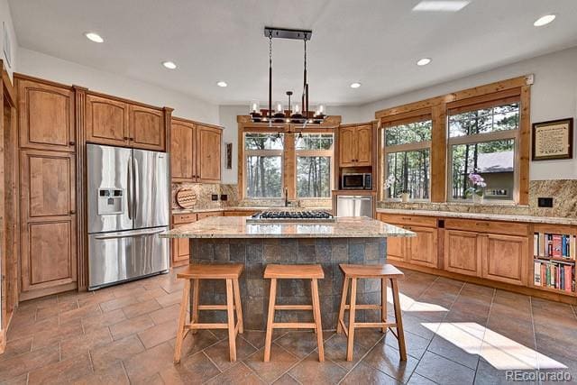 15947 Huckleberry Hts, Colorado Springs, CO 80908 - kitchen with stainless steel appliances, decorative backsplash, and a healthy amount of sunlight