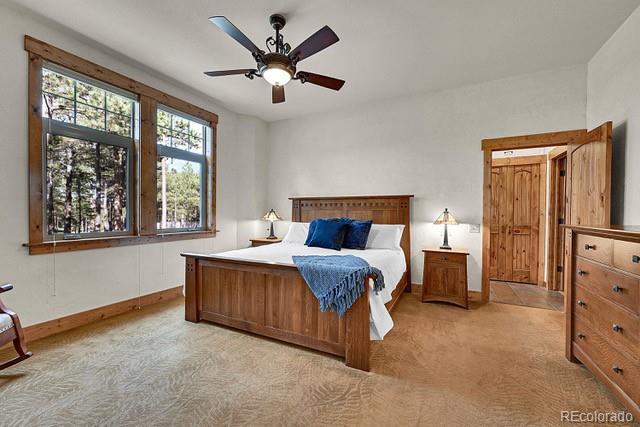15947 Huckleberry Hts, Colorado Springs, CO 80908 - bedroom featuring baseboards, ceiling fan, and light colored carpet