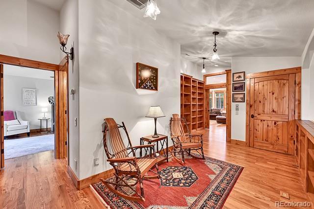 15947 Huckleberry Hts, Colorado Springs, CO 80908 - living area featuring baseboards, light wood-style flooring, and visible vents
