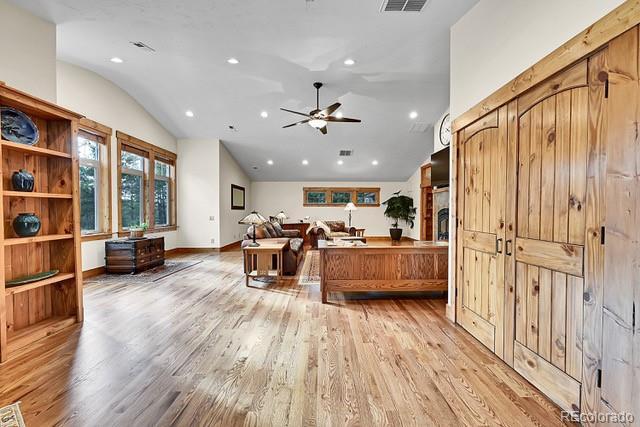 15947 Huckleberry Hts, Colorado Springs, CO 80908 - kitchen with ceiling fan, open floor plan, lofted ceiling, recessed lighting, and light wood-style flooring