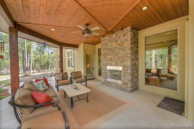 15947 Huckleberry Hts, Colorado Springs, CO 80908 - view of patio / terrace featuring ceiling fan and an outdoor living space with a fireplace