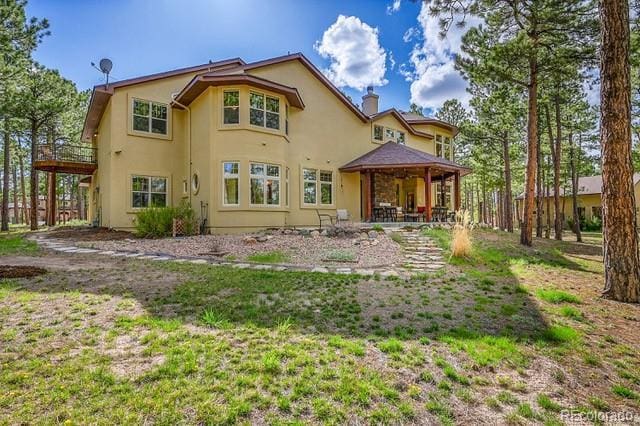 15947 Huckleberry Hts, Colorado Springs, CO 80908 - back of house with stucco siding