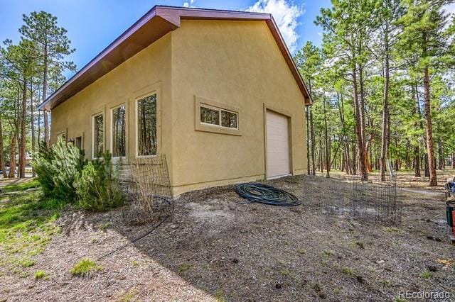 15947 Huckleberry Hts, Colorado Springs, CO 80908 - view of home's exterior featuring a garage and stucco siding