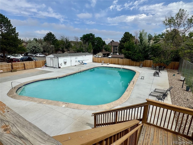 12166 Melody Dr Unit 202, Denver, CO 80234 - community pool with a fenced backyard, a patio, and a wooden deck
