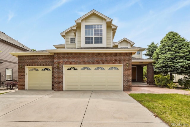6533 S Ouray St, Aurora, CO 80016 - traditional-style house with brick siding, driveway, an attached garage, and roof with shingles