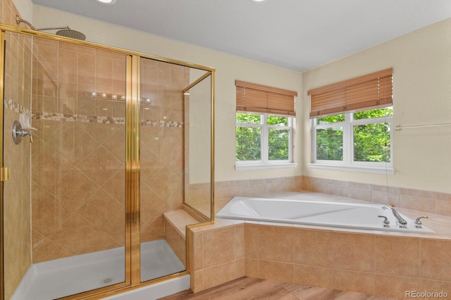 6533 S Ouray St, Aurora, CO 80016 - bathroom with a shower stall, a garden tub, and wood finished floors