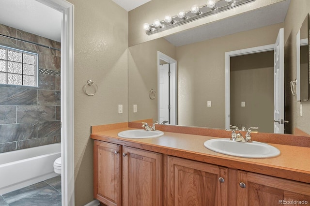6533 S Ouray St, Aurora, CO 80016 - bathroom featuring double vanity, toilet, and shower / bath combination