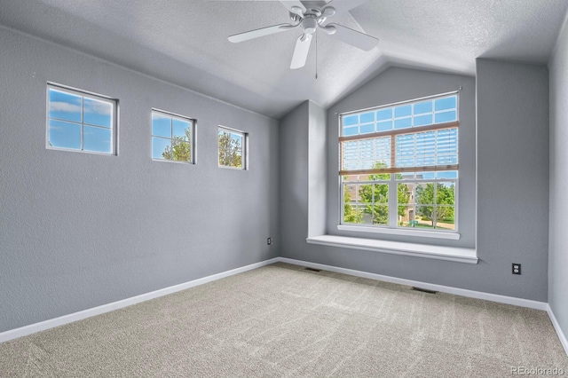 6533 S Ouray St, Aurora, CO 80016 - empty room featuring lofted ceiling, a ceiling fan, a textured ceiling, carpet flooring, and baseboards