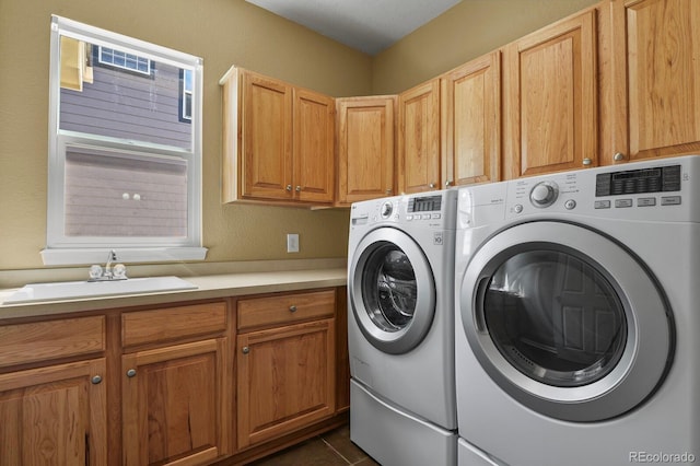6533 S Ouray St, Aurora, CO 80016 - laundry room with washer and clothes dryer, cabinet space, and dark tile patterned flooring