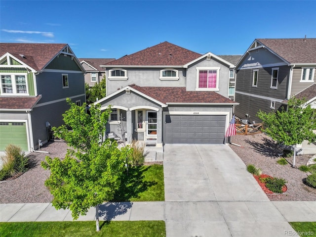 view of front of property with a garage, driveway, a residential view, and stucco siding