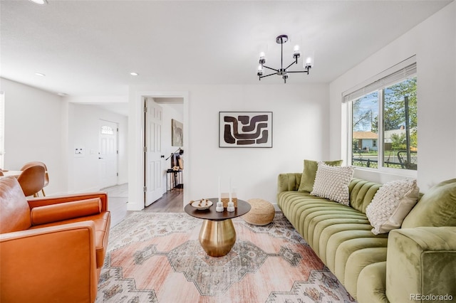 3249 W Alaska Pl, Denver, CO 80219 - living room featuring light wood finished floors, recessed lighting, baseboards, and a notable chandelier