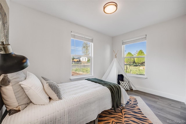 3249 W Alaska Pl, Denver, CO 80219 - bedroom featuring multiple windows, wood finished floors, and baseboards