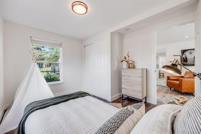 3249 W Alaska Pl, Denver, CO 80219 - bedroom featuring a closet, baseboards, and wood finished floors