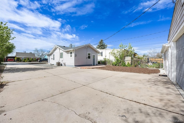 3249 W Alaska Pl, Denver, CO 80219 - exterior space with central air condition unit, driveway, and fence