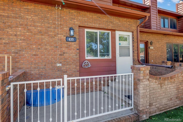 435 Dahlia St, Fort Morgan, CO 80701 - view of exterior entry with brick siding and a chimney