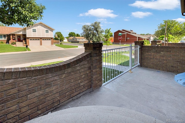 435 Dahlia St, Fort Morgan, CO 80701 - view of patio / terrace with an attached garage, driveway, and a residential view