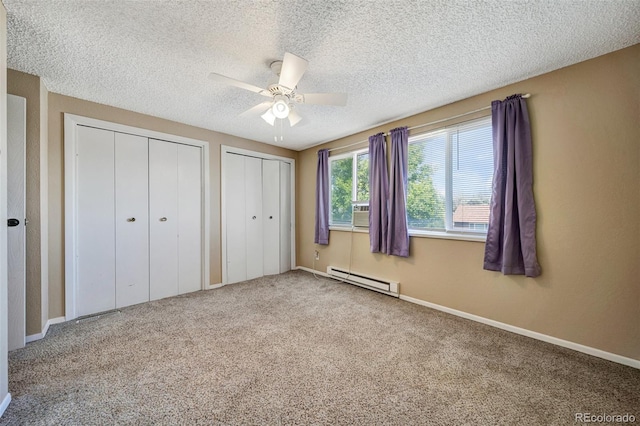 435 Dahlia St, Fort Morgan, CO 80701 - unfurnished bedroom featuring multiple closets, carpet, a baseboard heating unit, a textured ceiling, and ceiling fan