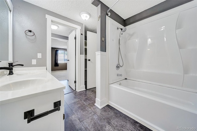 435 Dahlia St, Fort Morgan, CO 80701 - full bathroom with bathing tub / shower combination, a textured ceiling, and double vanity
