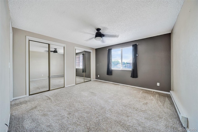 435 Dahlia St, Fort Morgan, CO 80701 - unfurnished bedroom featuring carpet flooring, a baseboard heating unit, multiple closets, a textured ceiling, and a ceiling fan