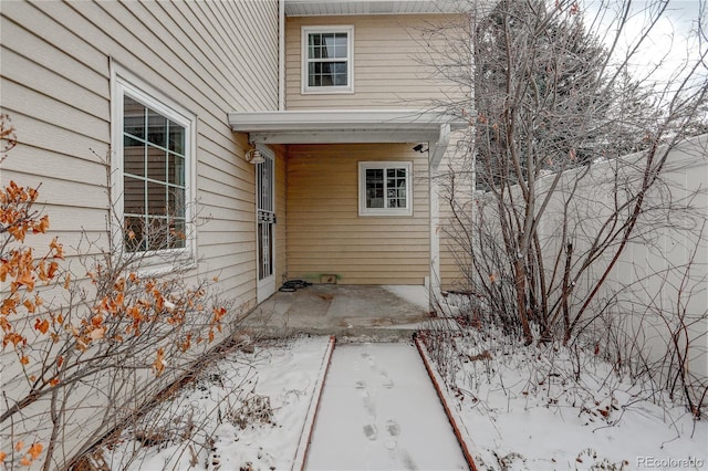 view of snow covered property entrance