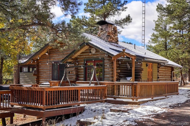 snow covered property with a wooden deck