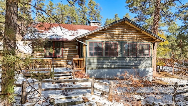 log home with a wooden deck