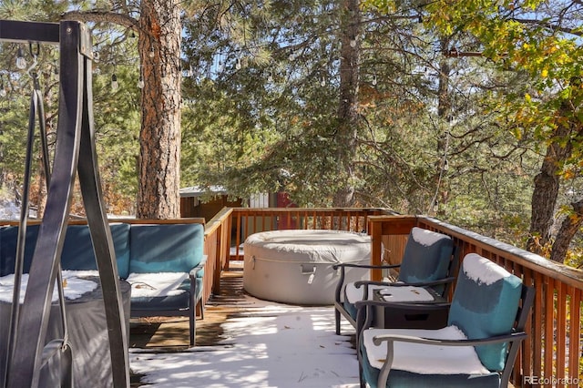 wooden deck featuring a hot tub