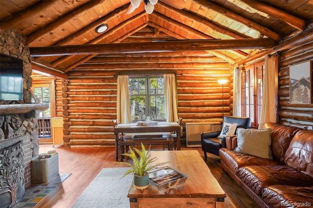 living room with hardwood / wood-style flooring, plenty of natural light, and log walls