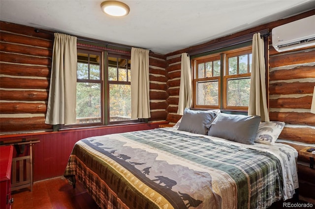 bedroom featuring multiple windows, log walls, and a wall mounted air conditioner