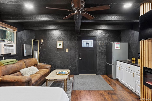 living room with ceiling fan, beamed ceiling, cooling unit, and dark hardwood / wood-style flooring