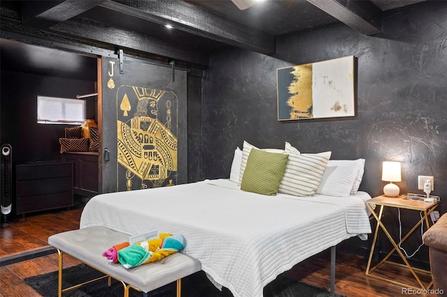 bedroom featuring beamed ceiling, a barn door, and dark hardwood / wood-style flooring