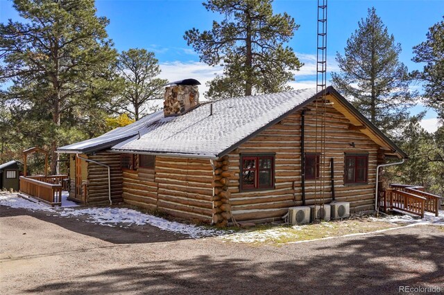 view of side of property with an outbuilding and ac unit