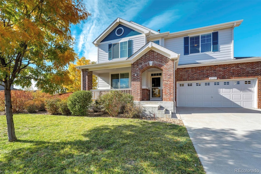 front facade featuring covered porch, a garage, and a front lawn