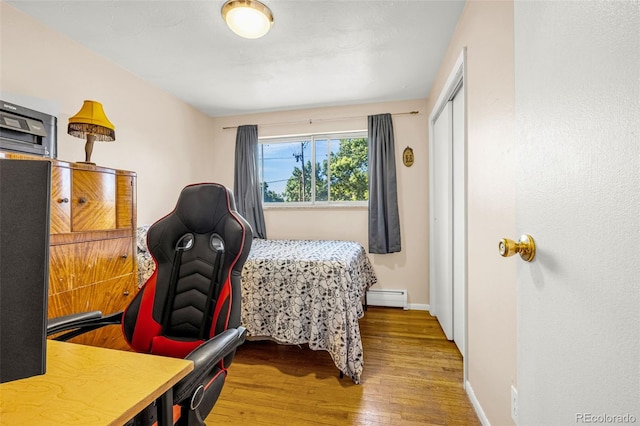 12475 W 38th Ave, Wheat Ridge, CO 80033 - bedroom with wood finished floors, a baseboard radiator, and a closet