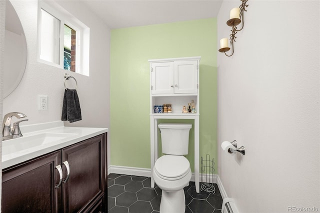 12475 W 38th Ave, Wheat Ridge, CO 80033 - bathroom featuring vanity, tile patterned flooring, and a baseboard heating unit