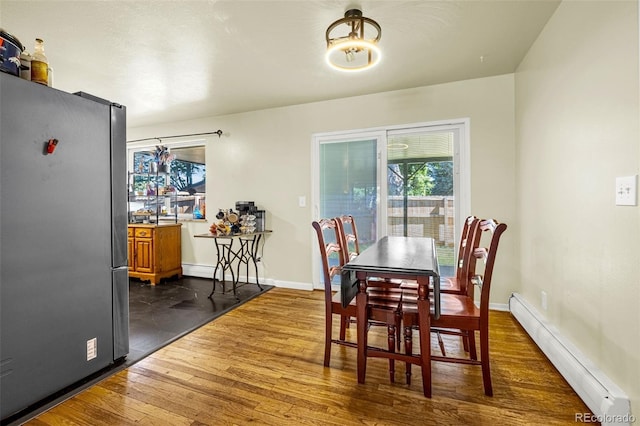 12475 W 38th Ave, Wheat Ridge, CO 80033 - dining space with a baseboard radiator and dark wood-style floors