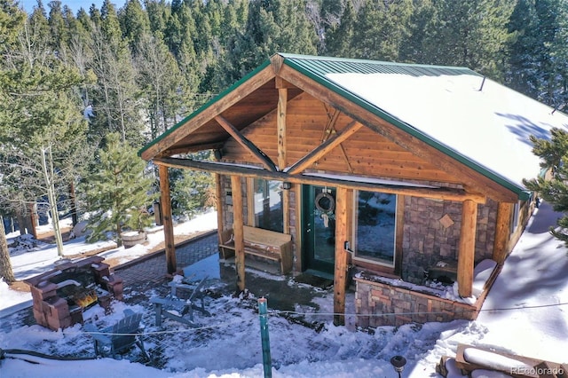526 Wakanda Trl, Woodland Park, CO 80863 - view of front of property featuring a wooded view, an outbuilding, and metal roof