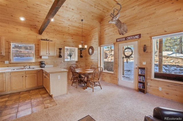 526 Wakanda Trl, Woodland Park, CO 80863 - kitchen featuring wooden walls, light brown cabinetry, vaulted ceiling with beams, and a sink