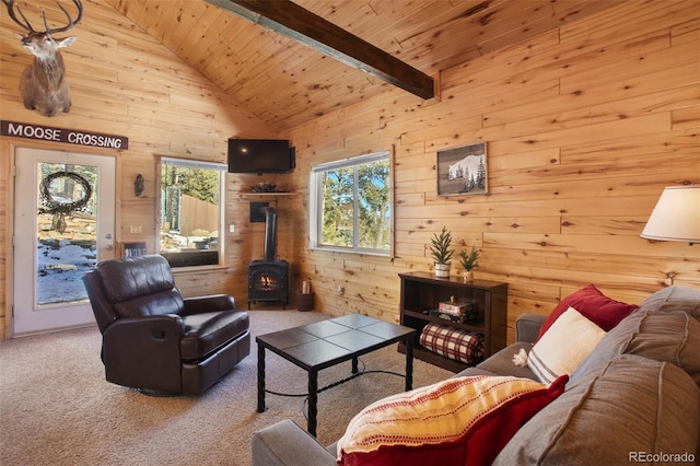 526 Wakanda Trl, Woodland Park, CO 80863 - carpeted living room featuring wooden ceiling, wood walls, high vaulted ceiling, a wood stove, and beam ceiling